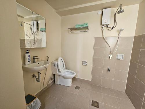 a bathroom with a toilet and a sink and a shower at Avida Abreeza 1bedroom with balcony in Davao City