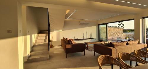 a living room with a couch and chairs at Phaedrus Living Venus Seaview Lighthouse Villa in Paphos