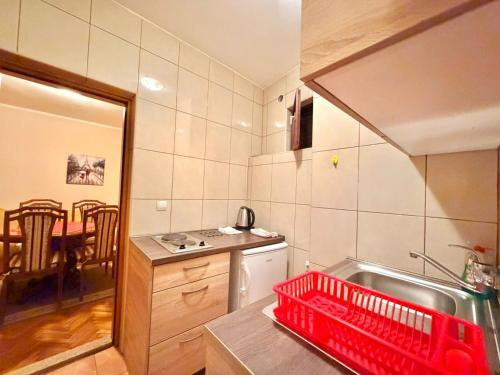 a kitchen with a red dish basket on the counter at Beachfront Apartments Oaza in Petrovac na Moru