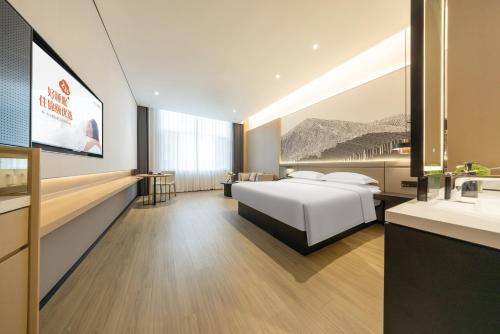Postel nebo postele na pokoji v ubytování Jin Yi Youxuan Hotel Ulanqab Wanda Branch 2