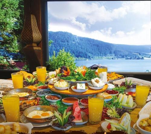 a table full of food with a view of the water at Abant Niz in Bolu