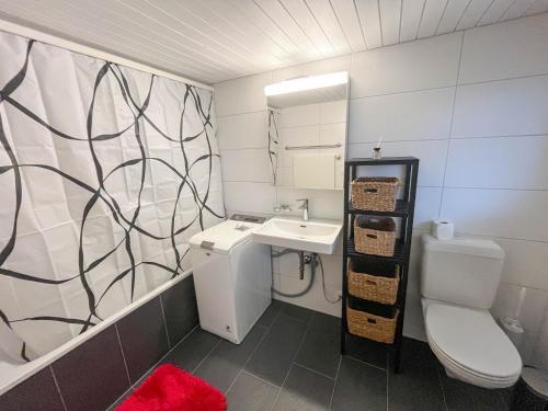 a bathroom with a toilet and a sink at Apartment im Winkel in Reinach