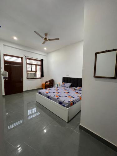 a bedroom with a bed in the middle of a room at Kamal kishori Dham Guest house in Barsāna