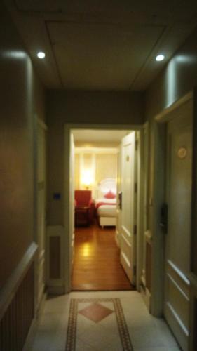 a hallway with a room with a bed in the background at Hotel Bright in New Delhi