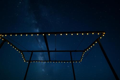 a star in the night sky with lights on it at VVIP GAJBAN Resort in Bikaner