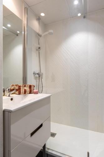 a bathroom with a white sink and a shower at Hôtel AKENA Nantes Orvault - Ouest in Orvault