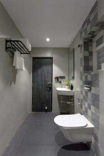a bathroom with a toilet and a sink at Kzar Park in Kolkata