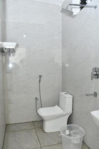 a bathroom with a toilet and a sink at Hotel MG Grand in Rāmeswaram