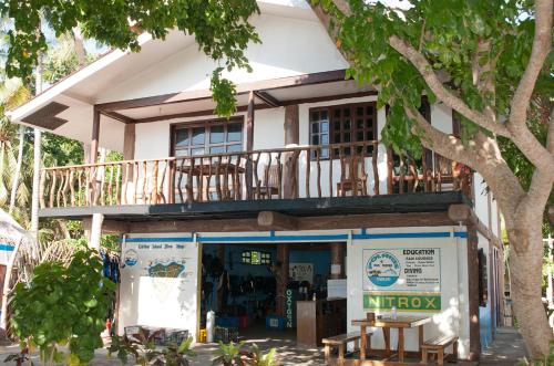 a building with a balcony on top of it at Polaris Beach and Dive Resort Inc in Loon