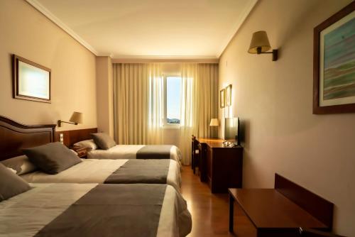 Ένα ή περισσότερα κρεβάτια σε δωμάτιο στο Hotel Restaurante Emilio