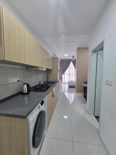 a kitchen with a washer and dryer in a room at City centre Majestice Suite KLCC in Kuala Lumpur