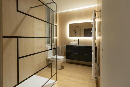 a bathroom with a toilet and a sink at Le Refuge des Isards - Chalet familial in Cauterets