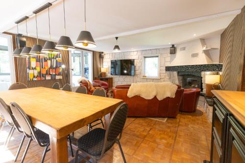 a kitchen and living room with a table and chairs at Le Refuge des Isards - Chalet familial in Cauterets