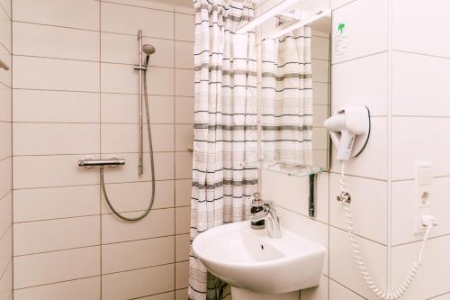 un baño con lavabo y ducha en Hotel Kleiner Markt, en Saarlouis