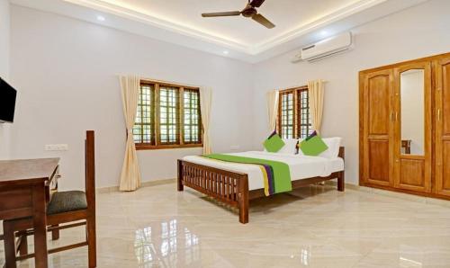 a bedroom with a bed and a piano at PALM GROVE By D2V in Cochin