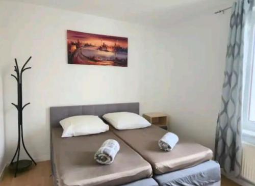 a bed with two pillows on it in a room at Comfortable room in a quiet apartment, exclusively for women in Dresden