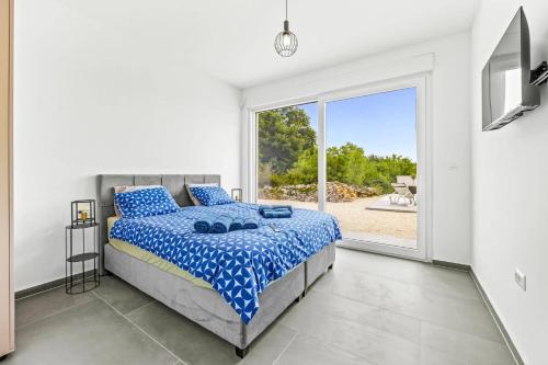 a bedroom with a bed and a large window at Villa Karolina by Villa Plus in Štokovci