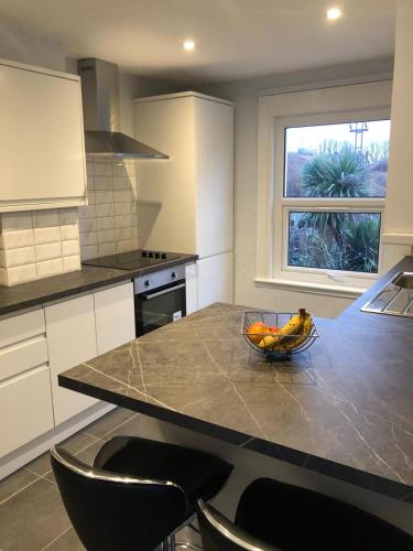 a kitchen with a bowl of fruit on a counter at 1 bedroom flat 15 minutes from Oxford Circus in London
