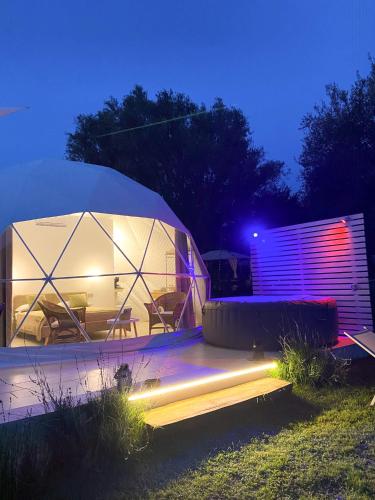 a large tent with a table and chairs in a field at La Fontana Glamping in Caria
