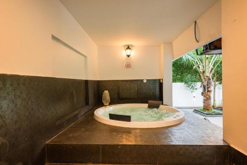 a large bath tub in a room with at Bangalore Bubble Stay 1BHK Villa - Bella in Denkanikota