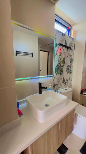 a bathroom with a white sink and a mirror at Comfy Bnb in Syokimau