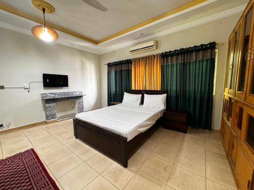 Postel nebo postele na pokoji v ubytování Mashal Guest House Islamabad