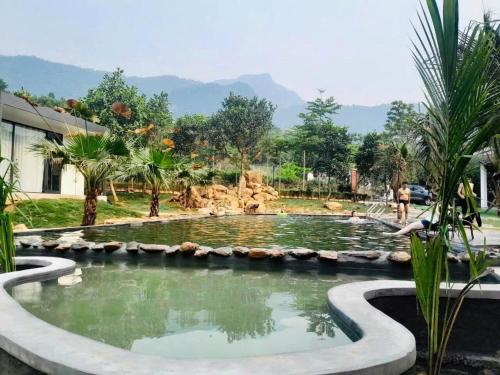 a pond in the middle of a park at Mường Dy Retreat 2 in Ba Vì