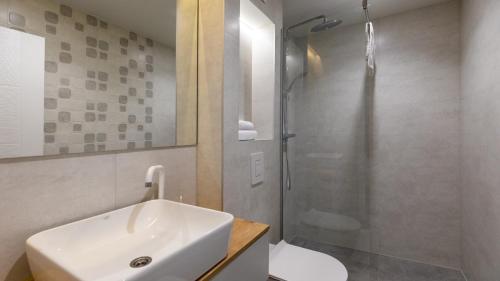 a white bathroom with a sink and a shower at Villa Tea - Kremena by Villas Guide in Blace