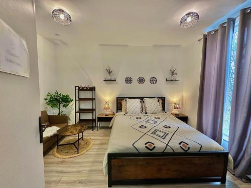 a bedroom with a bed and a chair and a table at Comfort CHU Lille in Lille