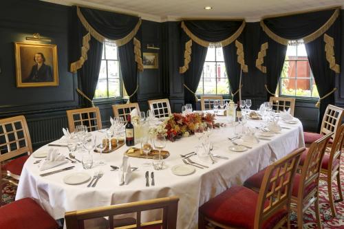 a dining room with a table with white table cloth at York Pavilion Hotel, BW Signature Collection in York