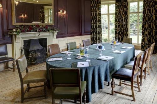 a dining room with a table and chairs and a fireplace at York Pavilion Hotel, BW Signature Collection in York