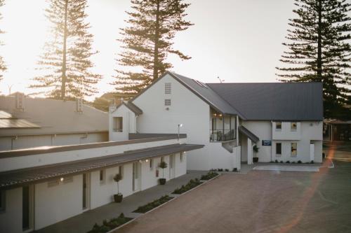 arial view of a white building with trees in the background at The Esperance Accommodation in Esperance