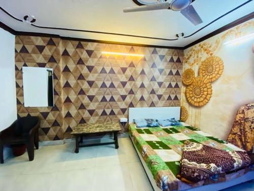a bedroom with a bed and a table and a chair at RS Hotel in Amritsar