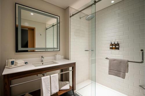 a bathroom with a sink and a shower with a mirror at Four Points by Sheraton Mexico City Colonia Roma in Mexico City
