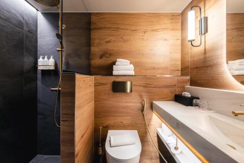 a bathroom with a toilet and a sink at Original Sokos Hotel Vaakuna Hämeenlinna in Hämeenlinna