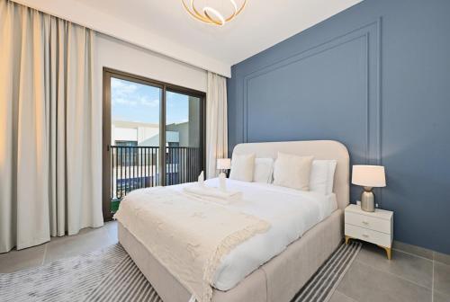 a bedroom with a large bed and a large window at Golden Stays - Luxe 4BR Villa Family-Friendly and Fully Equipped in Dubai