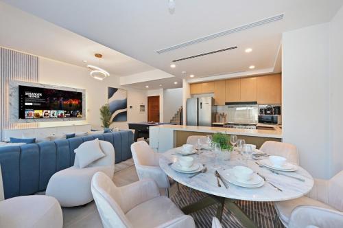 a dining room and kitchen with a table and chairs at Golden Stays - Luxe 4BR Villa Family-Friendly and Fully Equipped in Dubai
