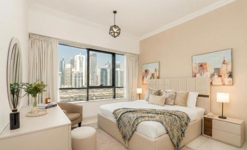 a bedroom with a bed and a large window at Ultimate Stay - Modern 1BR with City View Rooftop Pool Access in Dubai