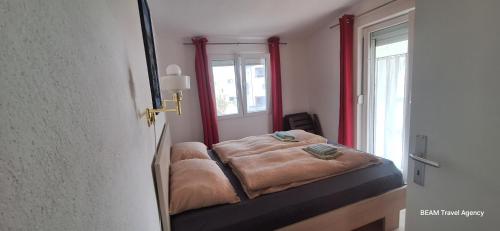 a small bed in a room with a window at Apartement Irena Vir in Vir