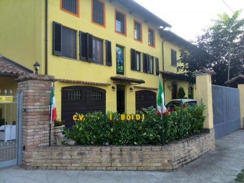 a yellow house with two flags in front of it at I Boidi in Nizza Monferrato