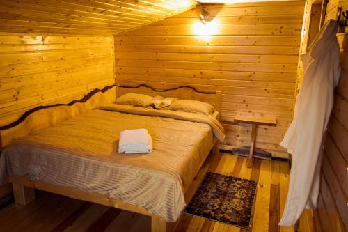 una camera con un letto in una baita di tronchi di Panoramic Escape a Broşteni