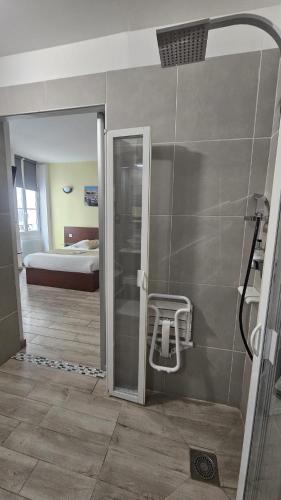 a bathroom with a shower and a room with a bed at Massilia hôtel in Marseille