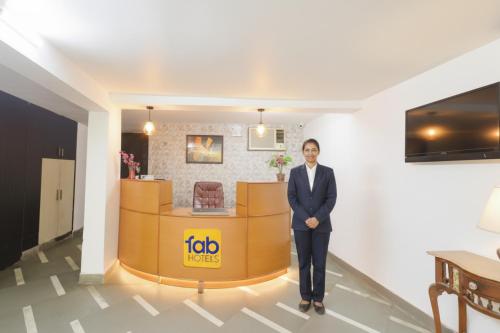 a man in a suit standing in a lobby at Via Chaudhary Palace in New Delhi