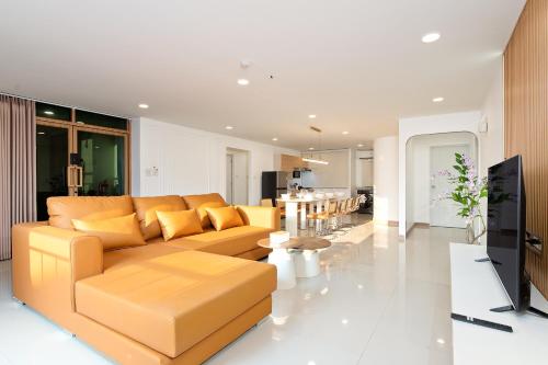 a living room with a couch and a table at Capitel Sathorn in Yan Nawa