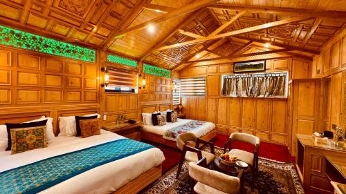 a train room with two beds and a chair at Kashmir Mahal Resorts by Stay Pattern in Srinagar