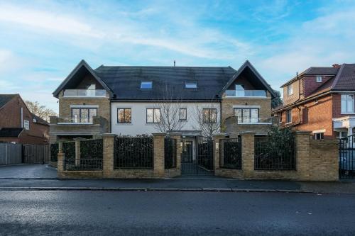 a large brick house with a black roof at The Isleworth Garden Retreat 3BR 2BA with Gated Parking in Isleworth