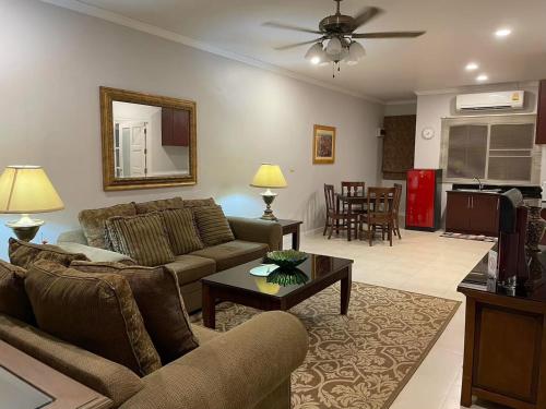 a living room with a couch and a table at Vacation Garden Villa in Thalang