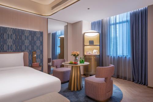 Ένα ή περισσότερα κρεβάτια σε δωμάτιο στο Nanyang Municipal Government Manxin Hotel