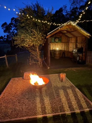 a fire bowl sitting on a table in a yard at The Bloom Farm Cottage 