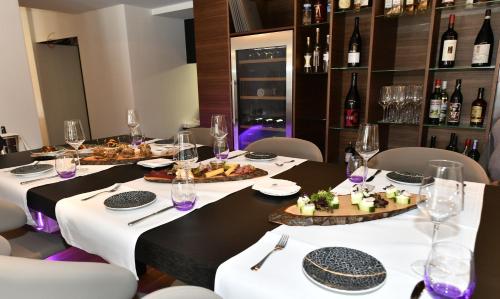 a dining room with a table with plates and glasses at Hotel Des Alpes in Luzern